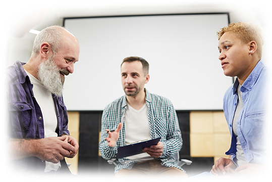 Side view portrait of senior man smiling during group therapy session with mature psychologist