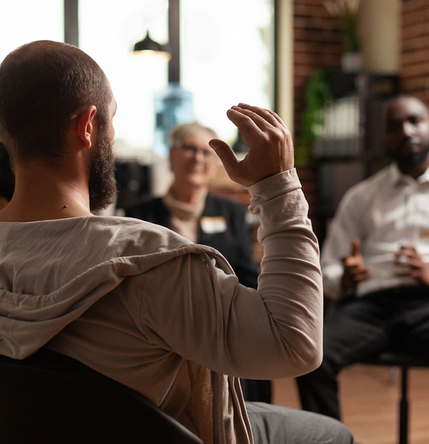 Man with addiction sharing mental health issues with group at aa meeting, talking to therapist. People having conversation about depression and rehabilitation at therapy session