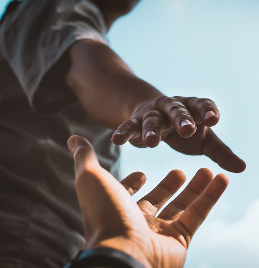 Help Concept hands reaching out to help each other in dark tone.