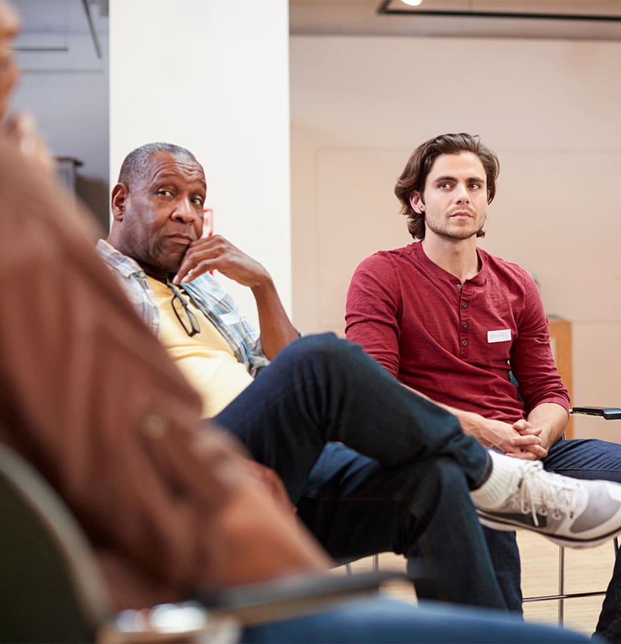 People Attending Self Help Therapy Group Meeting In Community Center